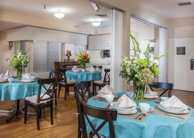 Dining room with set tables at Woodland Care Center